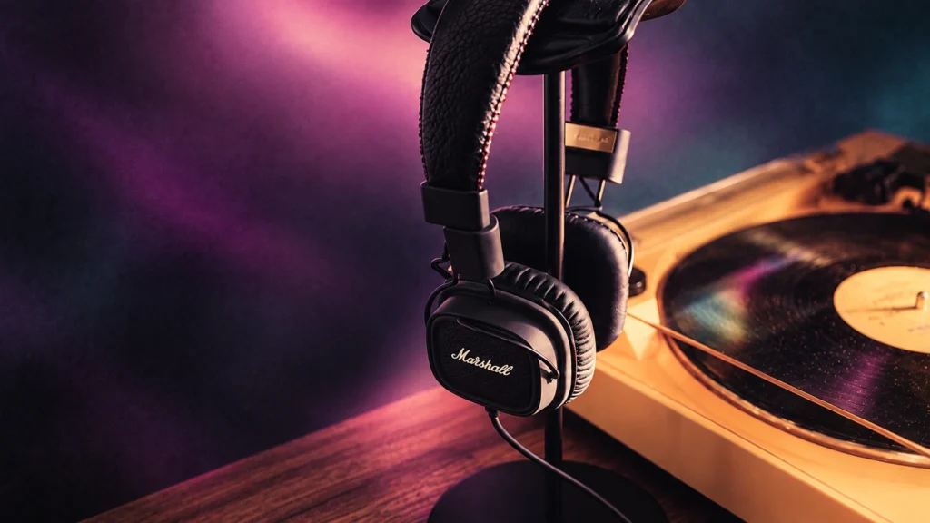 Headphones on their stand beside a turntable